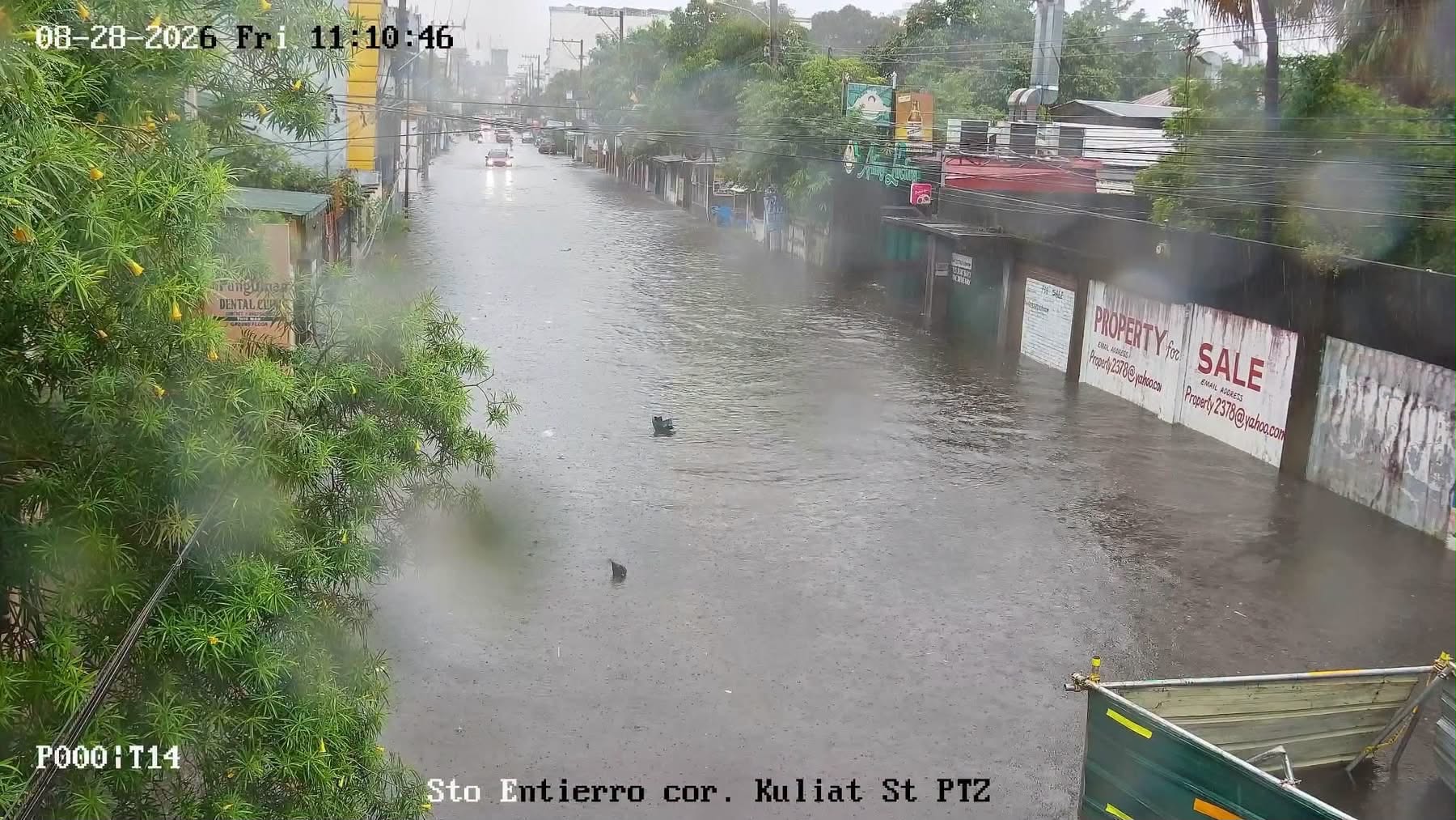 A traffic-camera view of floodwater covering Sto. Entierro Street at Kuliat Street in Angeles City during heavy rain.